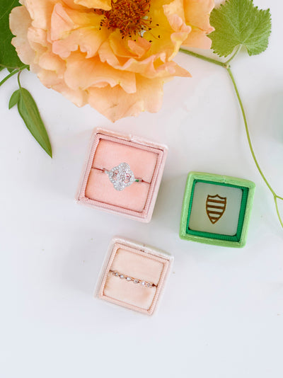 pink, green, and nude velvet ring boxes 